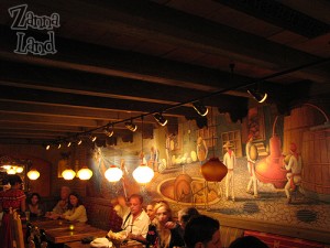 Tables sit along the right wall in front of a beautiful mural